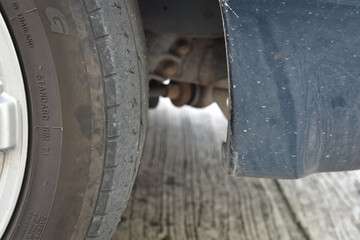Old tire with worn tread and scratch, worn old car tire tread with damaged, scratch, worn tire tread in the car wheel