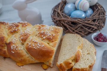 Sweet home made braided yeast bun for easter on a table