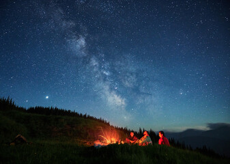 Fototapeta premium Recreation under night full starry sky in the mountains.