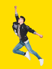 Happy handsome  young man in casual clothes smiling and jumping