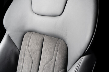 Modern luxury car black leather with alcantara interior. Part of black leather car seat details with white stitching. Interior of prestige car. Perforated leather seats isolated. Perforated leather. - obrazy, fototapety, plakaty