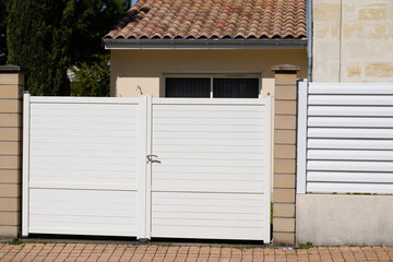 portal suburban steel metal gate white of home suburb street access house garden