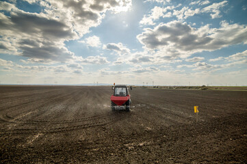 Tractor spreading artificial fertilizers