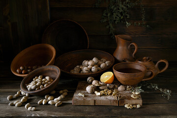 Nuts in an earthenware dish on a wooden table.