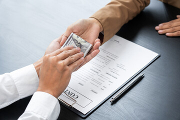 Businessmen give money to bribe partner secretly passing money, bribery and corruption concepts.