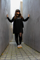 Fototapeta premium Young white girl posing among concrete blocks