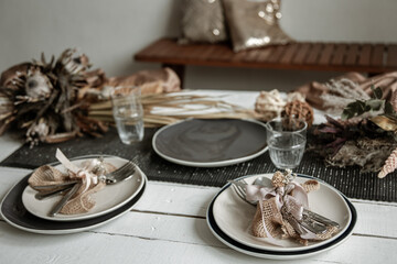 Festive table setting design with many hygge-style decor details.
