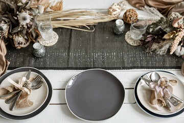 Festive table setting design with many hygge-style decor details.