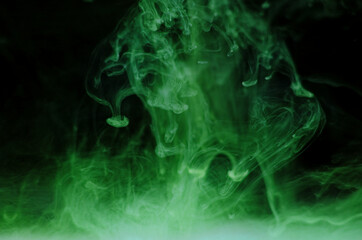 Ink swirls underwater. Ink cloud isolated on black background. Abstract effect of explosion of cosmos universe smoke with particles.