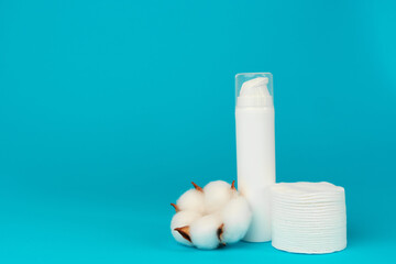 Stack of cotton discs and skicare cosmetic bottle