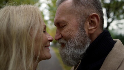 Portrait of happy couple smiling romantically. Cheerful elderly man and woman.