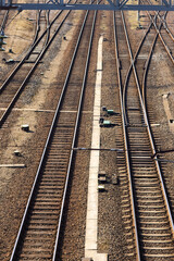 Fototapeta na wymiar Rusty railroad tracks on gravel. Top view of railways on a sunny day