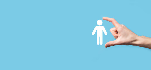 Male hand holding human icon on blue background. Human Resources HR management Recruitment Employment Headhunting Concept.Select team leader concept. Male hand click on man icon.Banner ,copy spase.
