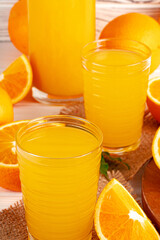 Close up of orange juice glass on wooden table