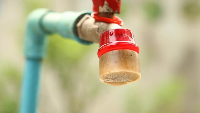 Water dropping from tap water  , climate change or lack of water concept  .