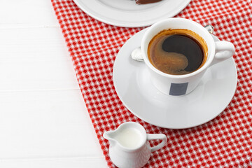 Cup of espresso coffee on saucer close up