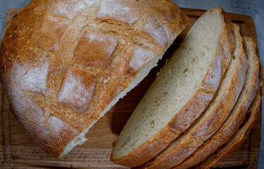 White round bread on a wooden board. Village bread.