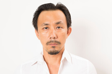 Head shot of middle aged Asian man looking at camera on white background.