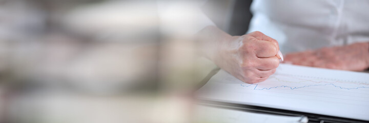 Angry businesswoman at her workplace; panoramic banner