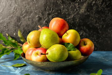 Fototapeta na wymiar Plate with tasty apple and pear fruits on table