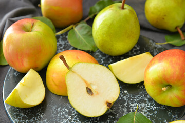 Board with tasty apple and pear fruits on table
