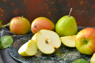 Naklejka na ściany i meble Board with tasty apple and pear fruits on table