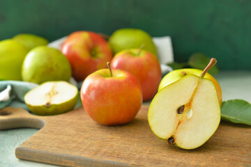 Board with tasty apple and pear fruits on table