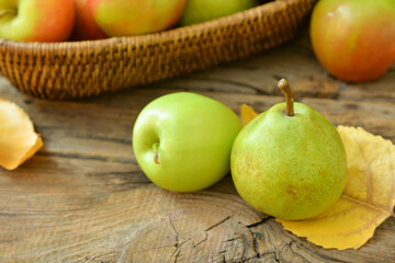 Tasty apple and pear fruits on table