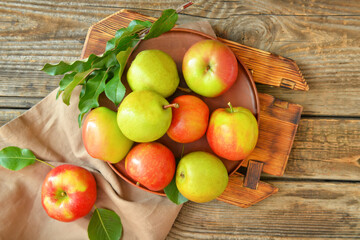 Naklejka na ściany i meble Plate with tasty apple and pear fruits on wooden background
