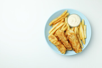 Plate with fried fish and chips, and sauce on white background