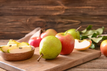 Board with tasty apple and pear fruits on table