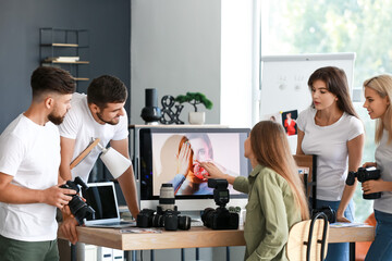 Mentor teaching young photographers in studio