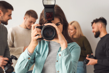 Female photographer taking picture in studio