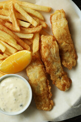 Plate with tasty fried fish and chips, close up