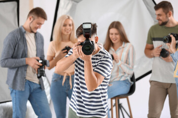 Male photographer taking picture in studio