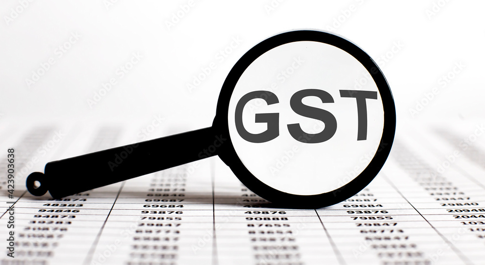 Aufkleber magnifier with text gst on the chart background