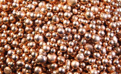 A background of many shiny gold metal balls.