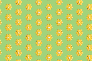 Creative pattern with yellow gingerbread flower on green background.. Sweet minimal concept