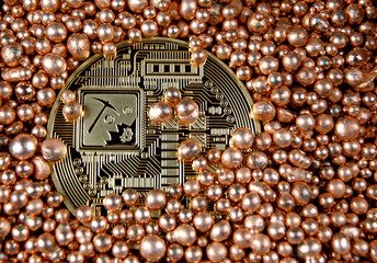 Physical gold bitcoin (reverse side) is semi-filled with gold balls.