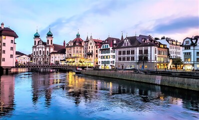 Jesuit Church along the river Reuss in Lucerne's old town. Evening view. Switzerland.