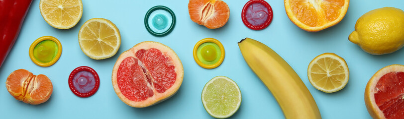 Sex concept with fruits and condoms on blue background