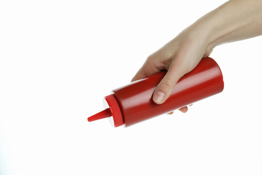 Female hand hold bottle of barbecue sauce, isolated on white background