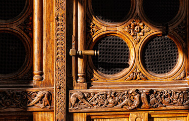 A very nice and detailed traditional Hungarian wooden door with handle and brown glass.