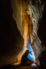 Speleologist taking a rest during cave exploration