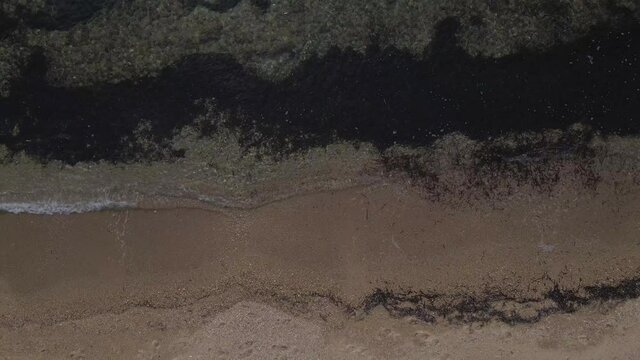 4k overhead teady clip of the ocean over a peninsula on  the tropical beach of Epanomi, Halkidiki, Greece