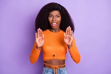 Photo of upset strict dark skin lady wear orange shirt showing palms isolated violet color...