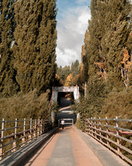 Beam metal suspension bridge on a sunny day in autumn.