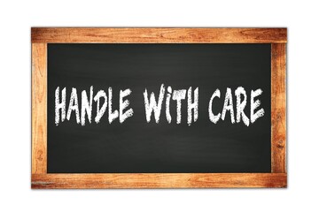 HANDLE  WITH  CARE text written on wooden frame school blackboard.