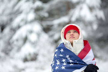 Woman with american flag in winter scenery