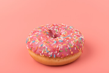 Fresh made Donuts isolated on pink background. Doughnuts are traditional sweet pastries. Copy space for text.